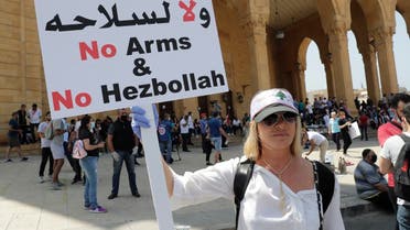 A Lebanese protester holds a placard in front of Mohammad al-Amin mosque during a demonstration in central Beirut, on June 6, 2020. (AFP)