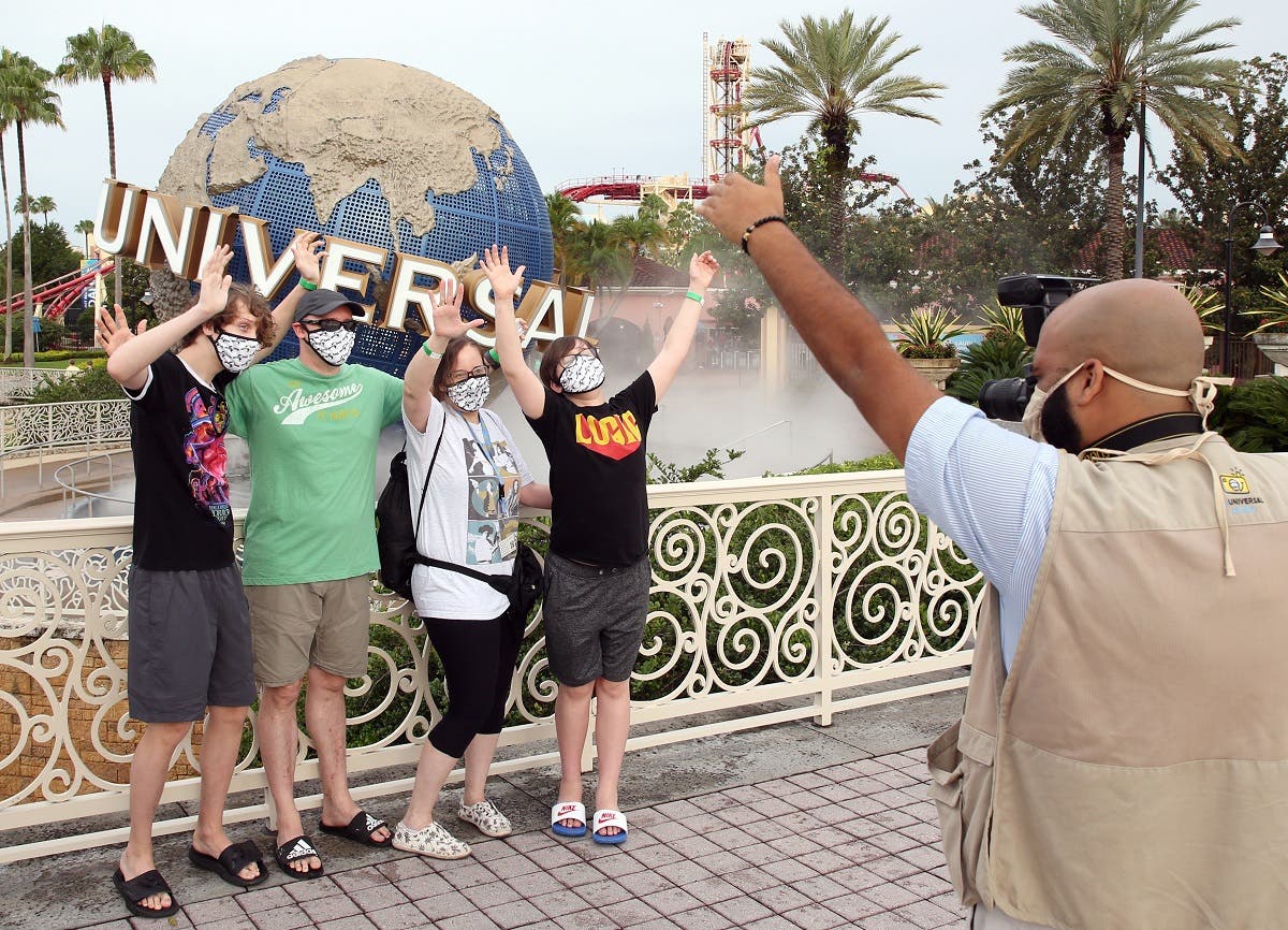 Visitors get a souvenir snapshot at Universal Studios theme park on the first day of reopening from the coronavirus pandemic, on June 5, 2020, in Orlando, Florida. (AFP)