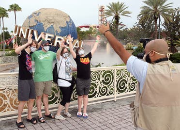 Visitors get a souvenir snapshot at Universal Studios theme park on the first day of reopening from the coronavirus pandemic, on June 5, 2020, in Orlando, Florida. (AFP)