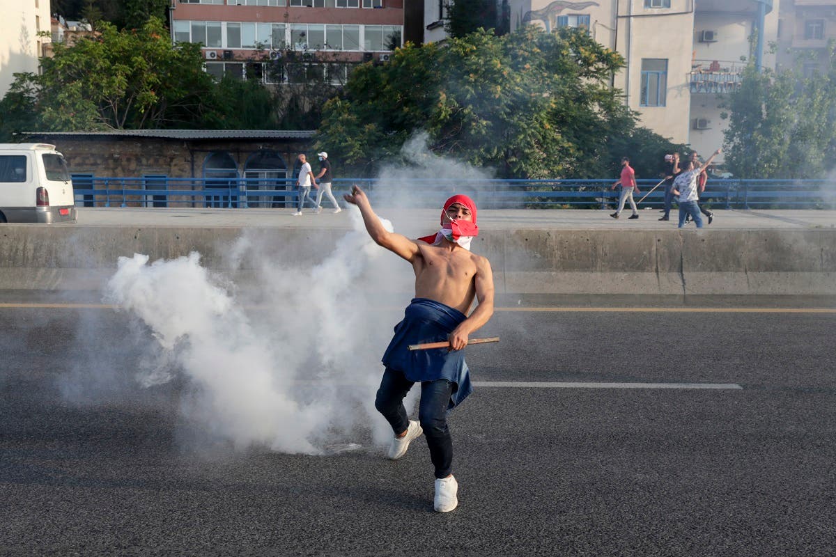 A Lebanese protester gestures amid clashes with riot police following a demonstration in central Beirut on June 6, 2020. (AFP)