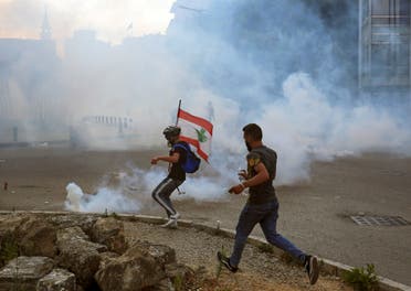 Demonstrators run amid a cloud of tear gas during a protest against the government performance and worsening economic conditions, in Beirut, Lebanon June 6, 2020. (Reuters)