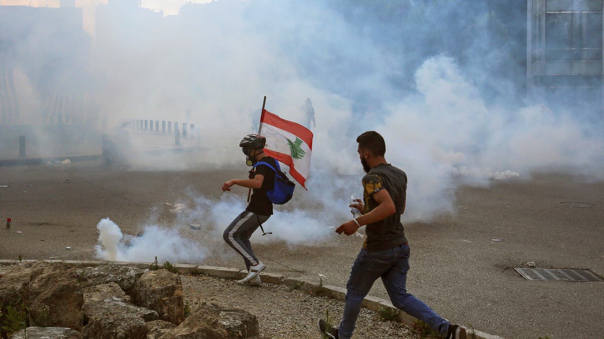 Demonstrators run amid a cloud of tear gas during a protest against the government performance and worsening economic conditions, in Beirut, Lebanon June 6, 2020. REUTERS/Aziz Taher