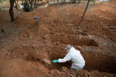 A cemetery worker digs graves in a section exclusively for COVID-19 victims at the Sao Luiz cemetery in Sao Paulo, Brazil, on June 4, 2020. (AP)