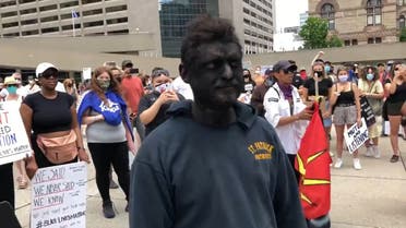 A man wears blackface at an anti-black racism rally in Toronto, Canada. (Twitter)