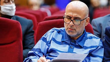Akbar Tabari, the former deputy head of Iran's administrative affairs, takes notes during his trial in the capital Tehran on June 7, 2020. (AFP)