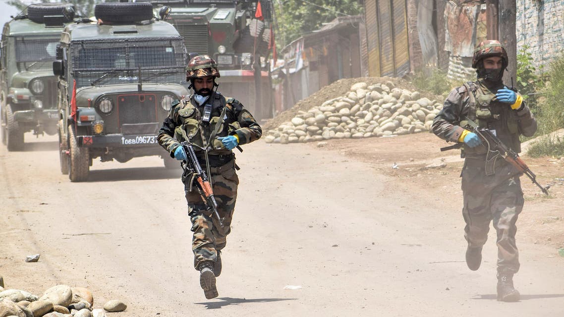 Security personnel run patrolling near the site of a gunbattle in Kangan area of south Kashmir's Pulwama district on June 3, 2020. (AFP)