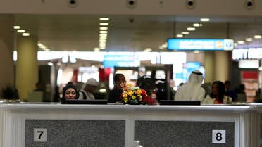 A local employee sits at the passport control at the newly opened Al-Maktoum International airport, the emirate's second airport in Dubai, on October 27, 2013. (AFP)