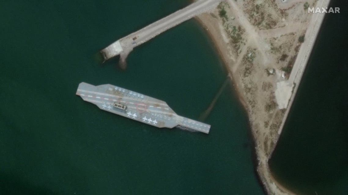 In this Sunday, June 7, 2020 satellite photo provided by Maxar Technologies, a fake aircraft carrier is seen off the coast of Bandar Abbas, Iran. As tensions remain high between Iran and the U.S., the Islamic Republic appears to have constructed a new mockup of an aircraft carrier off its southern coast for potential live-fire drills. The faux foe, seen in satellite photographs obtained by The Associated Press, resembles the Nimitz-class carriers that the U.S. Navy routinely sails into the Persian Gulf from the Strait of Hormuz, its narrow mouth that sees 20% of all the world's oil pass through it. (Satellite image ©2020 Maxar Technologies via AP)