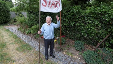 Alfons Leempoels poses next to a start line in his garden in Rotselaar, Belgium June 9, 2020. (Reuters)