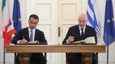 Greek Foreign Minister Nikos Dendias, right, and his Italian counterpart Luigi Di Maio asign an agreement following their meeting , in Athens, on Tuesday, June 9, 2020. (AP)