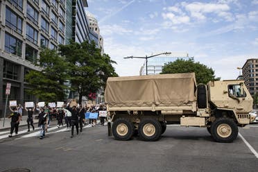 Protesters march past DC National Guard troops during demonstrations over the death of George Floyd, on June 2, 2020 in Washington, DC. (AFP)
