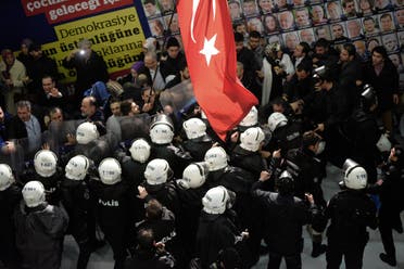 Riot police enter the headquarters of Zaman newspaper after using teargas and water cannons against the people gathered outside in support, in Istanbul on March 4, 2016. (AP)