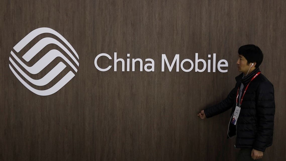 A man walks past the China Mobile logo at the Mobile World Congress in Barcelona. (Reuters)
