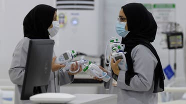 Bahraini health workers are pictured at the Sitra field Intensive Care Unit (ICU) hospital for COVID-19 patients, on May 4, 2020 in Sitra island south of the Bahraini capital Manama. The hospital, which is attached to a quarantine camp and spread-out over an area of 2400 square meters, is the first field Intensive Care Unit (ICU) to be setup far from a hospital and has its own lab, pharmacy, medical supply store, X-ray machines, and mobile dialysis units. It is run by 55 doctors and 250 nurses. It is the second field hospital out of five planned to add 500 ICU beds to Bahrain's health network.