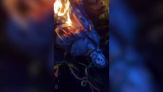 Christopher Columbus statue pulled down, draped in burning flag