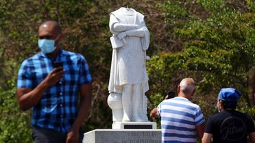 People photograph a statue depicting Christopher Columbus which had its head removed at Christopher Columbus Waterfront Park on June 10, 2020 in Boston, Massachusetts. (AFP)