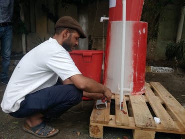 MSF handyman, Adeel, constructs a foot-operated handwashing point in MSF's hospital in Taiz Houban, May 2020. (MSF)