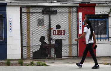 A pedestrian walks past a closed barber shop in Ward 7 as the coronavirus disease (COVID-19) outbreak continues in Washington, U.S., May 8, 2020. (Reuters)