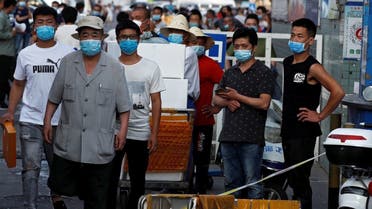 People are wearing face masks inside the Jingshen seafood market which has been closed for business after new coronavirus infections were detected, in Beijing, China, June 12, 2020. (Reuters)