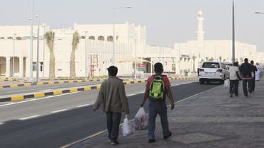 Migrant workers walk at Labor City, Qatar, January 13, 2016. (Reuters)