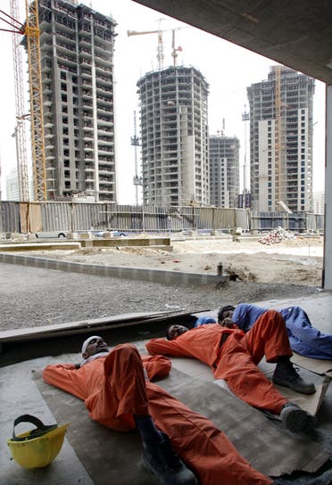 Workers take a nap on a hot afternoon at a construction site in Dubai. (File photo: Reuters)