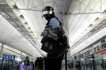 Riot police is seen during a mass demonstration after a woman was shot in the eye, at the Hong Kong international airport, in Hong Kong. (Reuters)