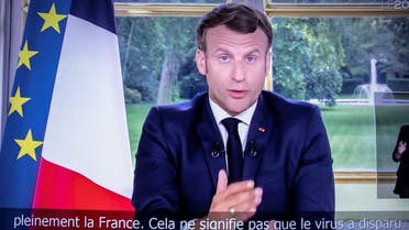 French President Emmanuel Macron is seen on a television screen in Paris on June 14, 2020 as he addresses the nation from the Elysee Palace during a televised speech, broadcast by French tv channel TF1. (AFP)