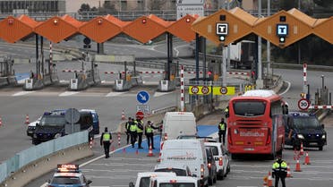 Border police officers check vehicles at the last toll gate entering Spain from France, following an order from the Spanish government to set up controls at its land borders over coronavirus. (Reuters)