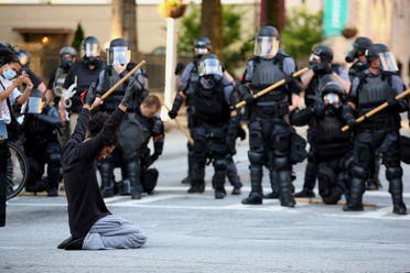 A file photo of a protester on his knees puts his hands up during a standoff with police in front of the Georgia State Capitol during a protest against the death of George Floyd, in Atlanta, Georgia, US. (File photo: Reuters)