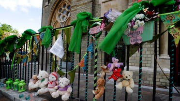Tributes are tied to the railings outside Notting Hill Methodist Church near Grenfell Tower in London, Sunday, June 14, 2020. (AP)