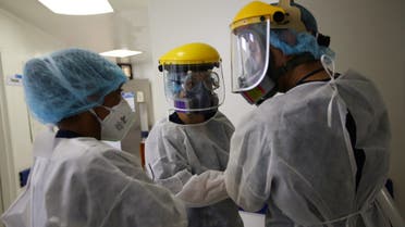 Medical staff talk to each other before entering the Intensive Care Unit (ICU) for patients suffering from the coronavirus disease (COVID-19), at the El Tunal hospital in Bogota, Colombia June 12, 2020. Picture taken June 12, 2020. REUTERS/Luisa Gonzalez