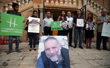 People hold placards during a vigil in solidarity with Italian Jesuit priest Father Paolo Dall'Oglio on July 29, 2015 in Beirut. (AFP)