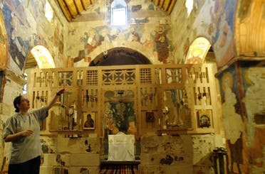 Sister Dima shows icons in the historic church of the Syrian Maronite monastery of Deir Mar Musa on July 11, 2007. (AFP)