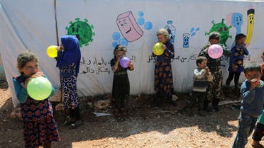 Displaced children play with balloons during an event organzied by Violet Organization, in an effort to spread awareness and encourage safety amid coronavirus disease (COVID-19) fears at a camp in Idlib. (Reuters)