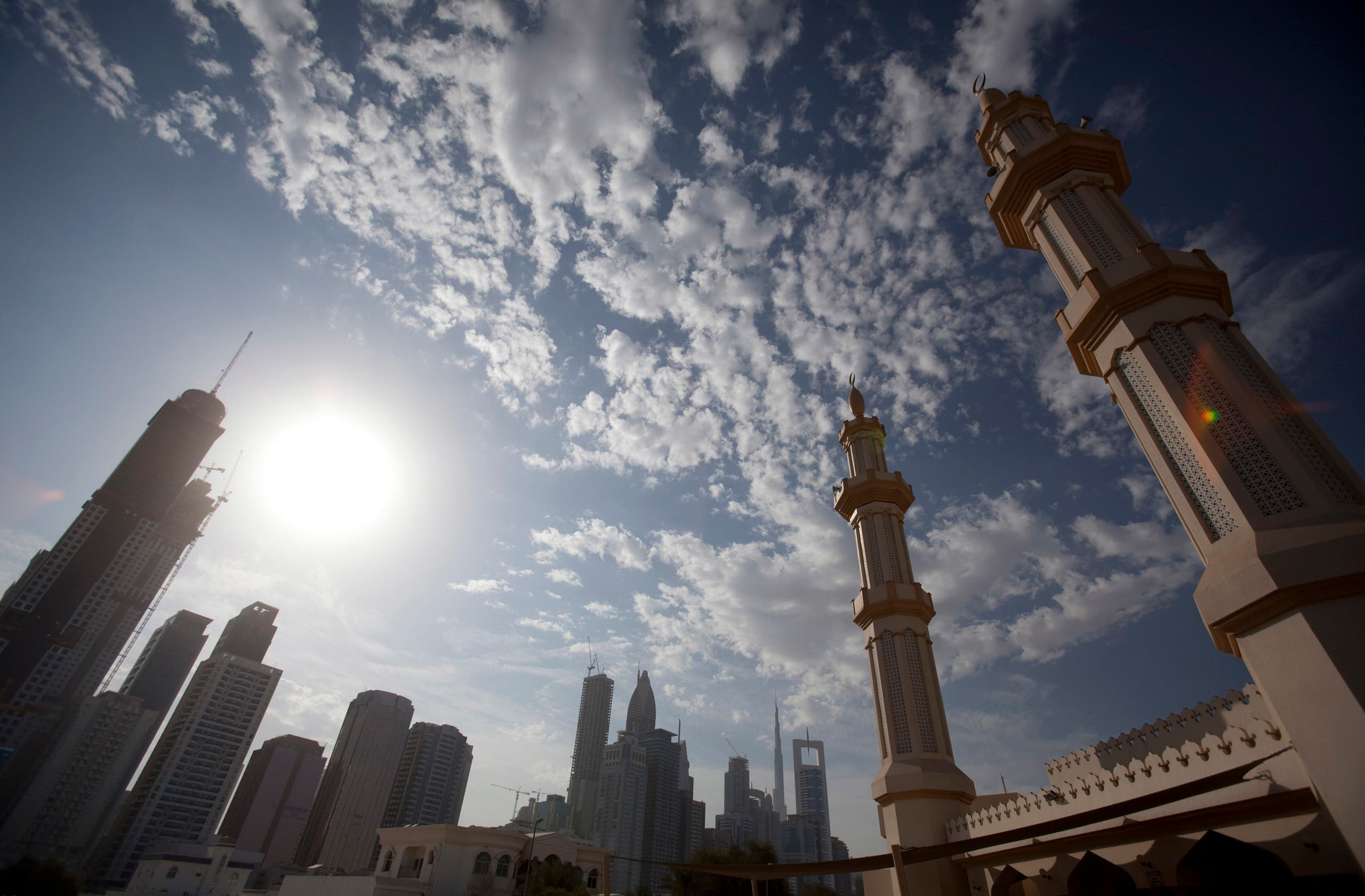 The twin minarets of a mosque are seen with office towers along Sheikh Zayed Road in Dubai. (AP)