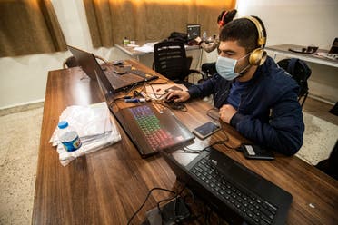 Technicians from the Kurdish educational authorities, edit and prepare recorded classes in Qamishli, northeast Syria, April 4. (AFP)