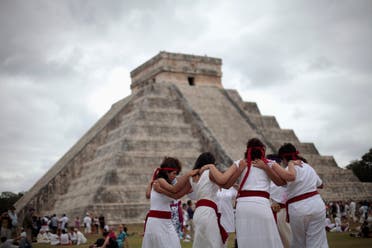 People perform a ritual in front of the pyramid of Kukulkan at the archaeological site of Chichen Itza in Yucatan State, December 21, 2012. (Reuters)