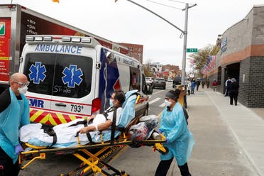 Medics move a patient outside of Elmhurst Hospital during the ongoing outbreak of the coronavirus disease in the Queens borough of New York, US, April 20, 2020. (Reuters)