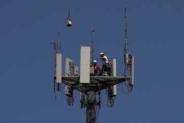 Workers install 5G telecommunications equipment on a T-Mobile tower in Seabrook, Texas. (Reuters)