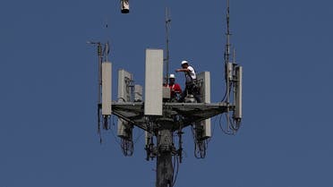 Workers install 5G telecommunications equipment on a T-Mobile tower in Seabrook, Texas. (Reuters)