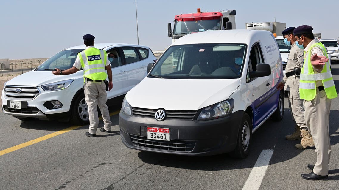 Emirati security forces man a checkpoint at the entrance of Abu Dhabi, on the highway linking Dubai to the capital, on June 2, 2020, after authorities cordoned off the city for a week to rein in the novel coronavirus.