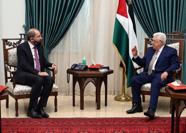 Palestinian president Mahmud Abbas (R) meeting with Jordan's Foreign Minister Ayman Safadi (L), clad in mask due to the COVID-19 coronavirus pandemic, in the West Bank city of Ramallah. (AFP)