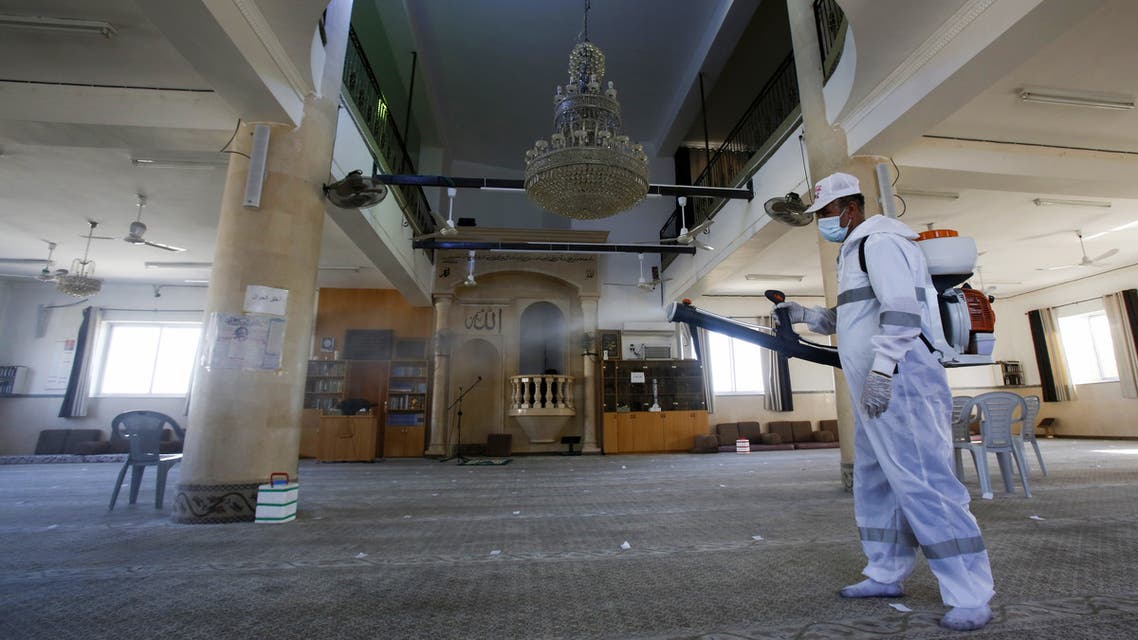 A Palestinian employee from Beit Sahur municipality disinfects a mosque after a coronavirus case from the village of Dar Salah, east of the west bank city of Bethlehem, was discovered among the prayers the previous day, on June 15, 2020. 
