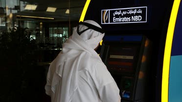 A customer uses an ATM machine at the Emirates NBD head office in Dubai, UAE. (File photo: Reuters)