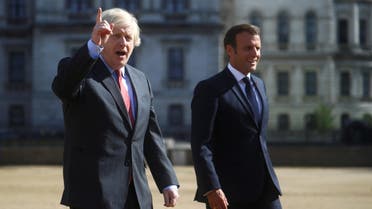 British Prime Minister Boris Johnson gestures as he and French President Emmanuel Macron walk, after watching The Red Arrows and La Patrouille de France perform a flypast, at Horse Guards Parade in London, Britain, June 18, 2020. REUTERS/Hannah McKay/Pool