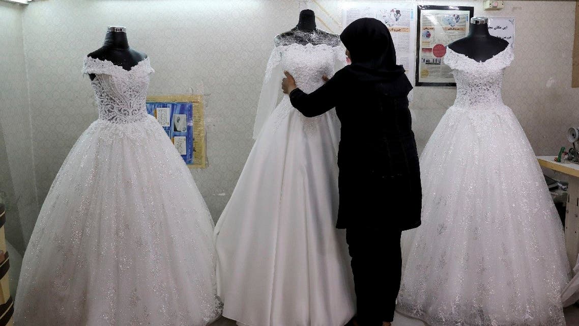 A worker adjusts a display of wedding dresses in downtown Tehran, Iran. (File photo: AP)