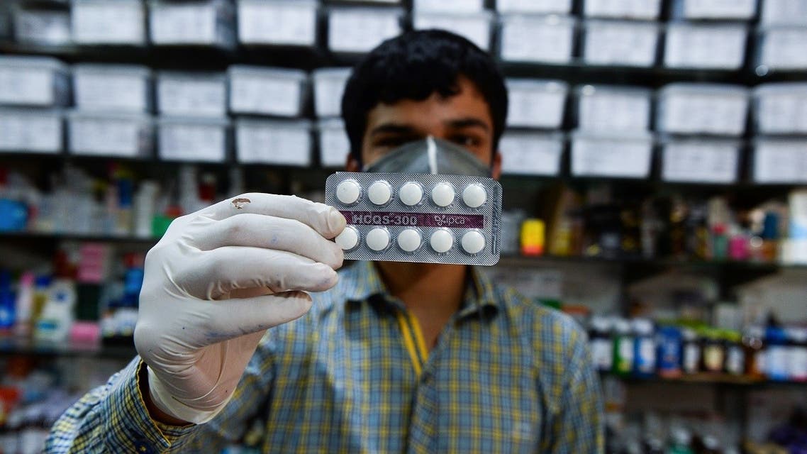 This photo taken on April 27, 2020 shows a pharmacy employee displaying hydroxychloroquine (HCQ) tablets in his store in New Delhi. (AFP)