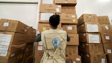 A World Food Program (WFP) worker arranges relief packages at a warehouse designated to the United Nations for humanitarian aid for Africa to combat the outbreak of the coronavirus disease (COVID-19), at the Bole International Airport in Addis Ababa, Ethiopia April 14, 2020. REUTERS/Tiksa Negeri