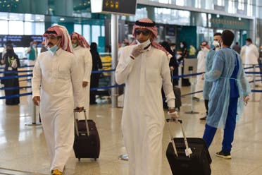 Saudi passengers queue for a temperature check at terminal 5 in the King Fahad International Airport, designated for domestic flights, in the capital Riyadh. (File photo: AFP)