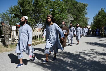 Taliban prisoners walk in a line during their release from the Bagram prison, next to the US military base in Bagram. (File photo)